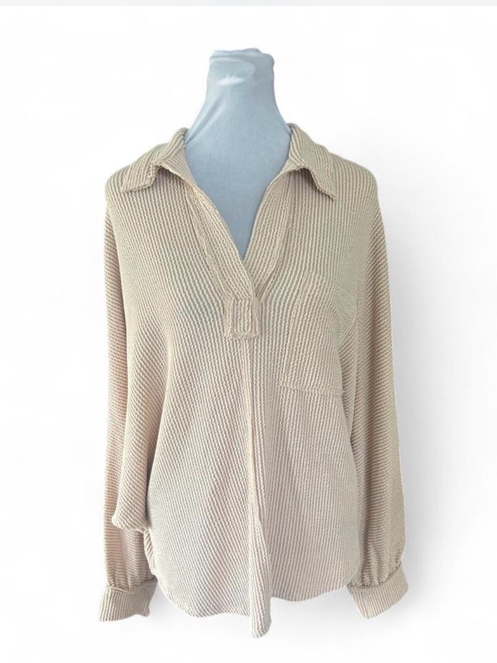 Cream ribbed knit blouse with button-up front and long sleeves, size M